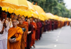 Buddhist monks walk down a road asking for alms during the annual Vesak festival, in Colombo